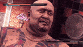 a bald man with a tattoo on his chest is playing a video game called yakuza
