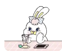 a cartoon bunny is drinking a drink through a straw while sitting at a table .