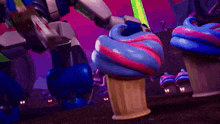 an ice cream cone with pink and blue swirls on it
