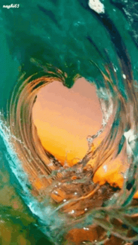 GIF of a wave tube shaped like a heart with a setting sun in the background.