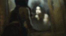 a woman is standing in front of a mirror looking at herself .