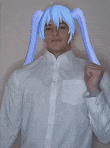 a man wearing a white shirt and a blue wig with pigtails