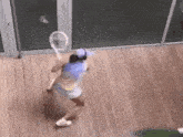 a woman is swinging a tennis racket on a wooden deck