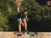 a man is doing a trick in front of a sign that says ' baturan o. ' on it