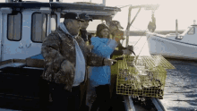 a group of people standing on a boat with a yellow cage in front of a boat that says ' captain ' on it