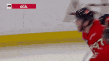 a hockey player in a red jersey with the word goal on the bottom