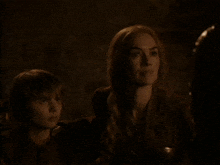 a woman in armor is standing next to a man in armor .
