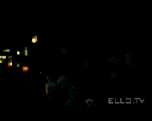 a man and woman are hugging each other in a dark room