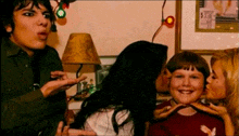 a girl kisses a boy on the cheek while another girl kisses another boy