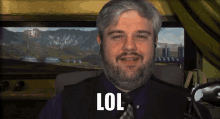 a man with a beard says lol in front of mountains