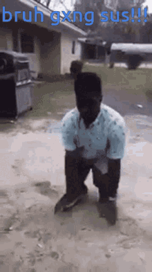 a man in a blue shirt is kneeling in the dirt with the words bruh gxing sus written above him