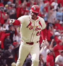 a baseball player for the st. louis cardinals is pointing at the crowd