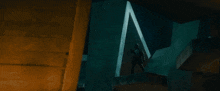 a man in a helmet is standing on top of a building with a triangle in the background