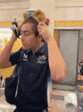 a man wearing headphones and a shirt that says red bull on it