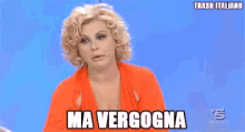a woman in an orange dress is flexing her muscles and the words ma verogna are above her