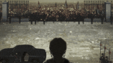 a woman stands in front of a crowd of people