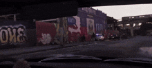 a police car is parked in front of a wall with the word mind written on it