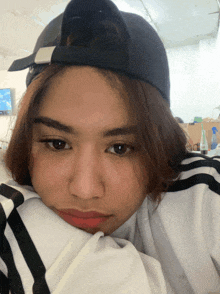 a young woman wearing a black hat and a white shirt