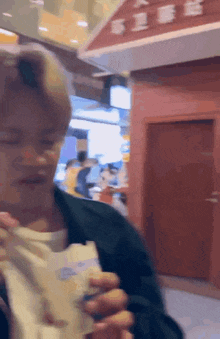a blurry picture of a man eating a sandwich