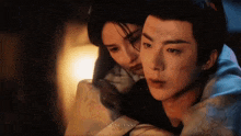 a man and a woman are sitting next to each other in a room .