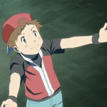 a boy wearing a red hat and a red shirt giving a thumbs up