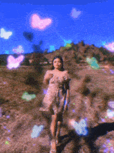 a woman in a dress is walking through a field of butterflies
