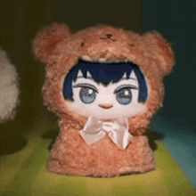 a stuffed animal wearing a teddy bear costume and a bow tie
