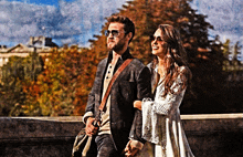 a man and a woman are walking across a bridge