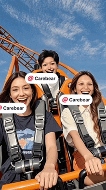 three people are riding a roller coaster and one of them has a sticker that says carebear on it