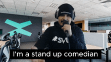 a man with a mustache singing into a microphone with the words i 'm a stand up comedian on the bottom