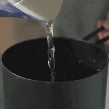 Pouring Water Into The Pot Two Plaid Aprons GIF
