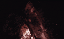 a woman with a necklace around her neck is holding a candle