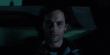 a close up of a man 's face in a dark room