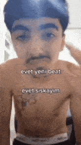 a shirtless young man with a mustache is standing in front of a mirror .