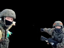 two soldiers wearing masks and helmets are holding guns .