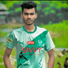 a man wearing a green shirt that says savvy on it
