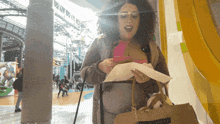 a woman holding a piece of paper and a bag that says united states of america