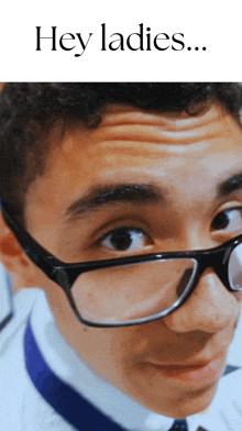 a close up of a man wearing glasses with the words hey ladies written above him