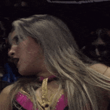 a close up of a woman 's face with long blonde hair