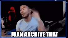 a man is sitting in front of a computer screen with the words `` juan archive that '' written on the screen .
