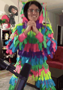 a woman wearing a colorful costume is standing in front of a microphone