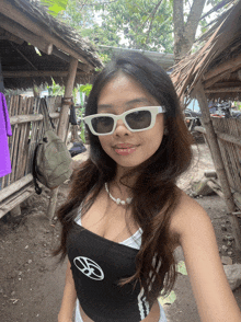 a woman wearing sunglasses and a black top with a volkswagen logo