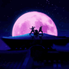 a group of people standing in front of a full moon