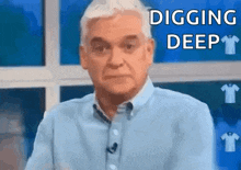 an older man in a blue shirt is digging deep