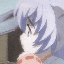 a close up of a person 's face with purple hair and a pink object .
