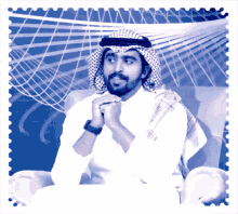 a man with a beard wearing a white shirt and scarf