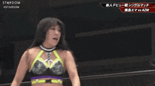 a female wrestler in a purple top is standing next to a sign that says stardom