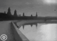 a black and white photo of a body of water with the letter t on the bottom right