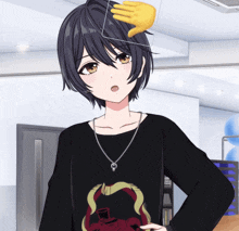 a person with a hand on their head wearing a black shirt