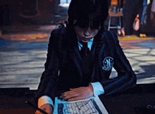 a girl in a school uniform with the letter n on her chest